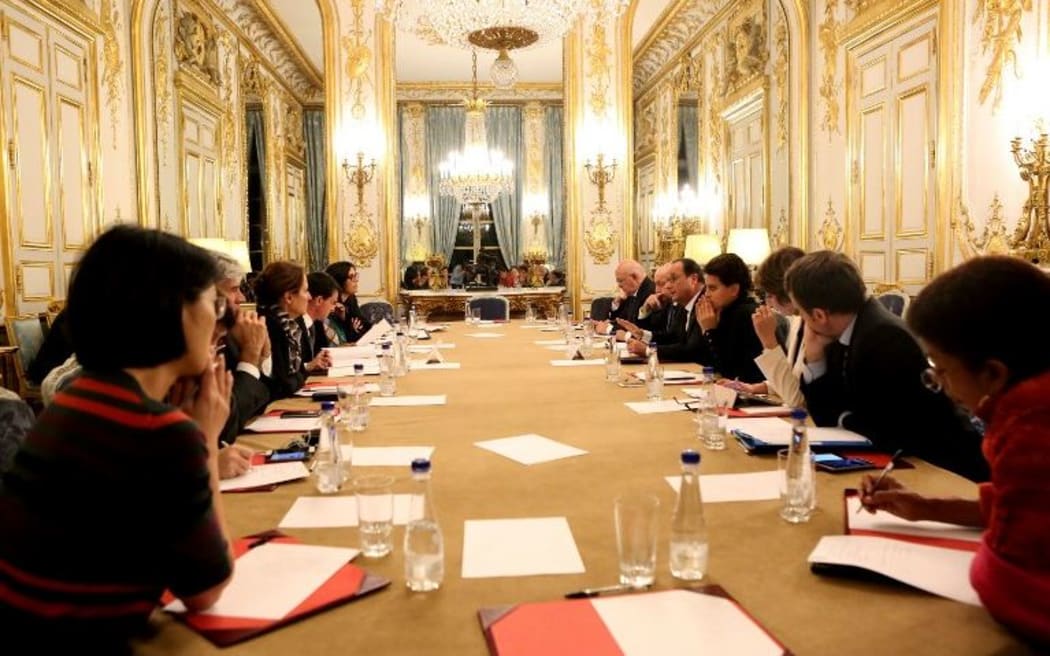 French president Francois Hollande (5-R) addresses an emergency meeting at the Elysee Palace early on November 14, 2015.