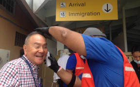 Ministry of Health staff screening all arriving passengers at Amata Kabua International Airport in Majuro