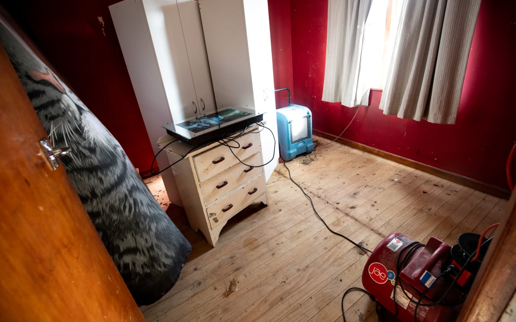 A dehumidifier runs inside a home that was drenched during the flood event in the Tasman District