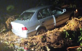 A Taranaki family's car was caught in a massive slip on State Highway 3.