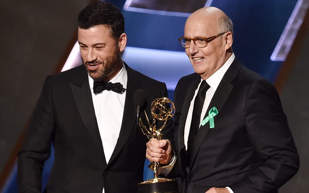 Actor Jeffrey Tambor (R) accepts Outstanding Lead Actor in a Comedy Series for Transparent from TV personality Jimmy Kimmel onstage during the 67th Annual Primetime Emmy Awards at Microsoft Theater on September 20, 2015 in Los Angeles, California. Kevin Winter/Getty Images/AFP