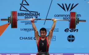 Papua New Guinea's Morea Baru competes in the men's 65kg weightlifting event on day two of the Commonwealth Games at the NEC Arena in Birmingham, central England, on July 30, 2022. (Photo by Darren Staples / AFP)