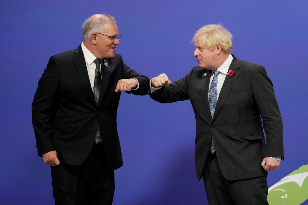 Britain's Prime Minister Boris Johnson greets Australia's Prime Minister Scott Morrison as they arrive to attend the COP26 UN Climate Change Conference in Glasgow, Scotland on November 1, 2021.