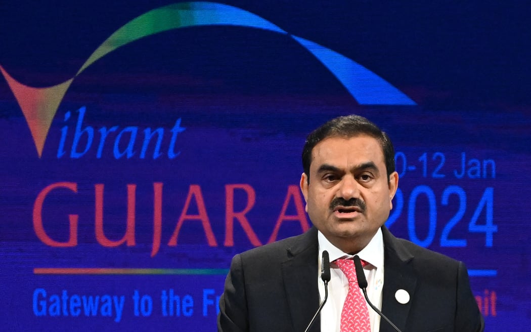 (FILES) Chairperson of Indian conglomerate Adani Group, Gautam Adani addresses a gathering during the inaugural session of Vibrant Gujarat Global Summit 2024 in Gandhinagar on January 10, 2024. - Billionaire Indian industrialist Gautam Adani has been charged with paying hundreds of millions of dollars of bribes and hiding the payments from investors, US prosecutors said on Wednesday.
With a business empire spanning coal, airports, cement and media, the chairman of Adani Group has been rocked in recent years by corporate fraud allegations and a stock crash.
The close acolyte of Hindu nationalist Prime Minister Narendra Modi, a fellow Gujarat native, is alleged to have agreed to pay more than $250 million in bribes to Indian officials for lucrative solar energy supply contracts. (Photo by Punit PARANJPE / AFP)