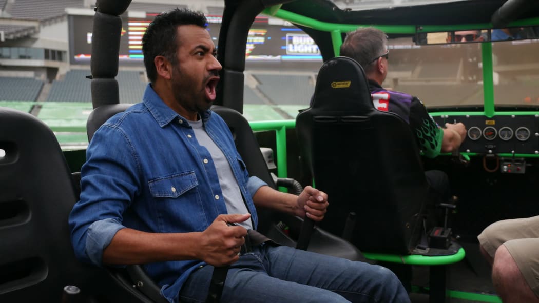 Kal Penn goes for a ride in a monster truck in This Giant Beast That is the Global Economy.