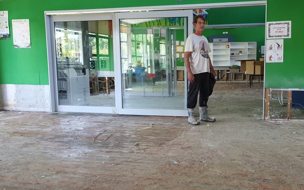 School principal Simon Couling, in a classroom after they were hosed out by firefighters following flooding in Tīnui, near the Wairarapa coast, during Cyclone Gabrielle.