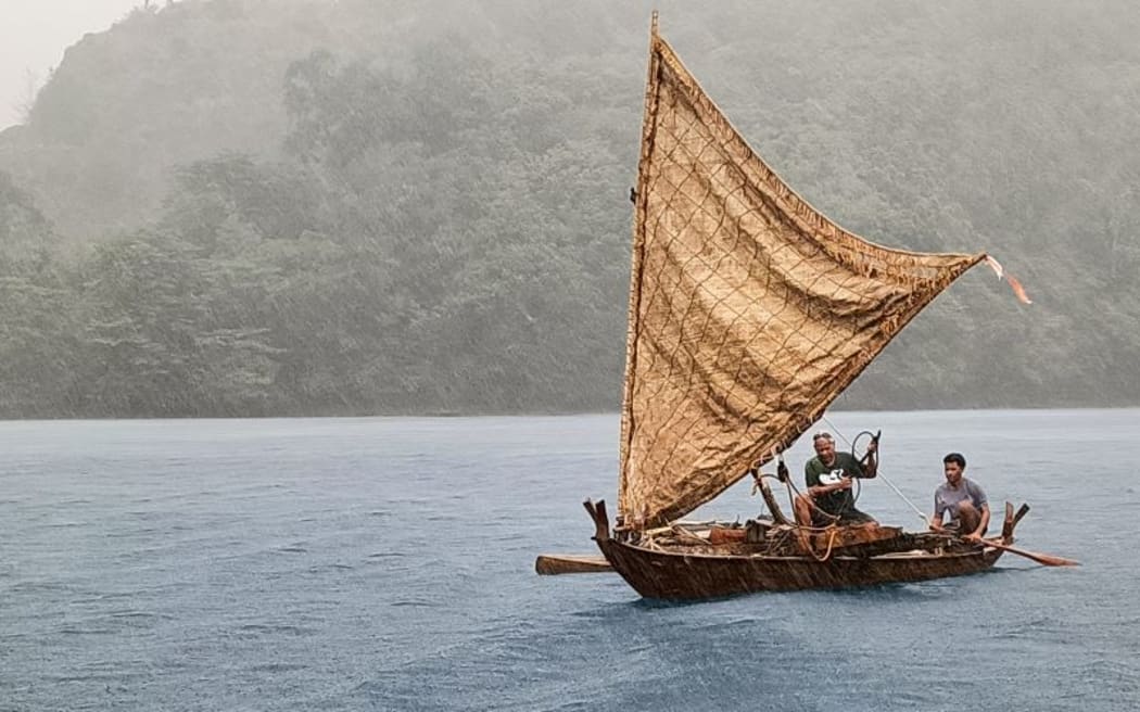 Master navigator Sesario Sewralur trims the sail of a traditional Palauan canoe.
