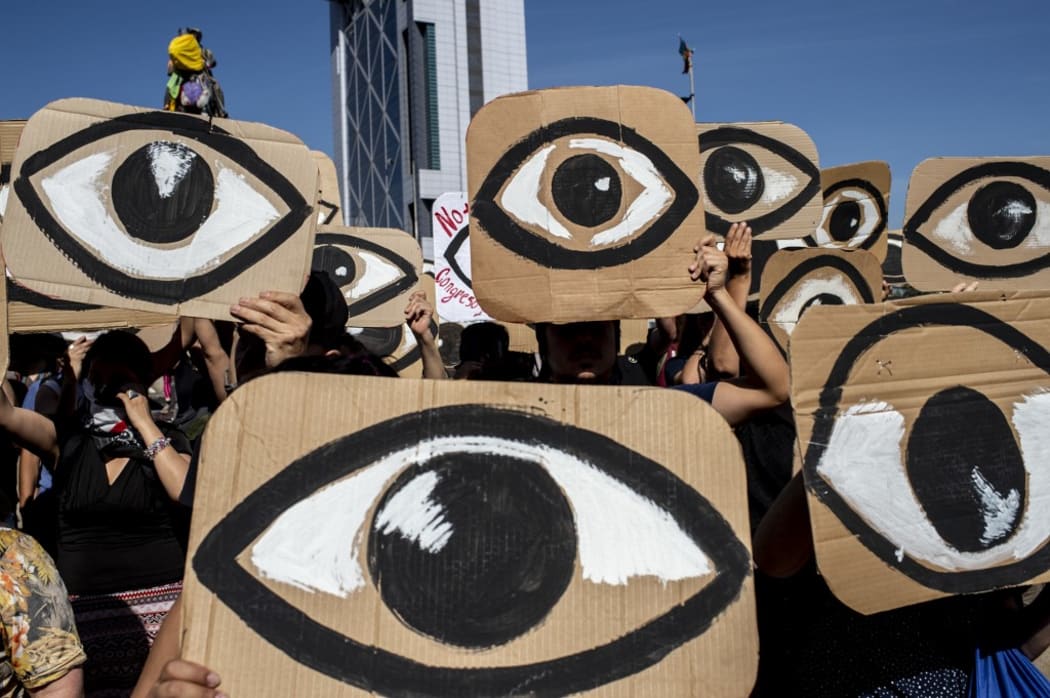 Demonstrators hold placards depicting eyes -in reference to police pellets reaching demonstrators' eyes- during a protest against Pinera's government in Santiago, on December 10, 2019.