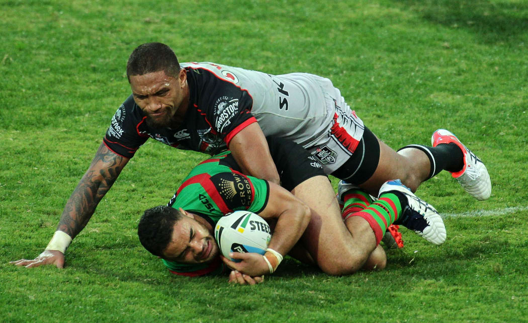 South Sydney Rabbitohs' Dylan Walker being tackled by New Zealand Warriors' wing Manu Vatuvei.