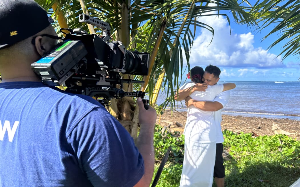 A young I'iga hugs his wife (dramatic recreation).