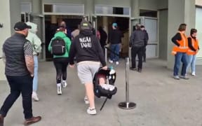 Workers enter an Alliance meeting, at which it was announced the meat co-operative would close its South Canterbury plant with the loss of 600 jobs.