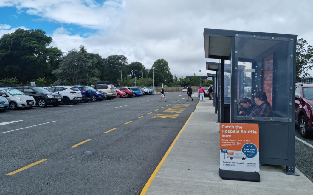 People waiting for the shuttle service from the Deans Avenue Park and Ride carpark to Christchurch Hospital, January 2023.