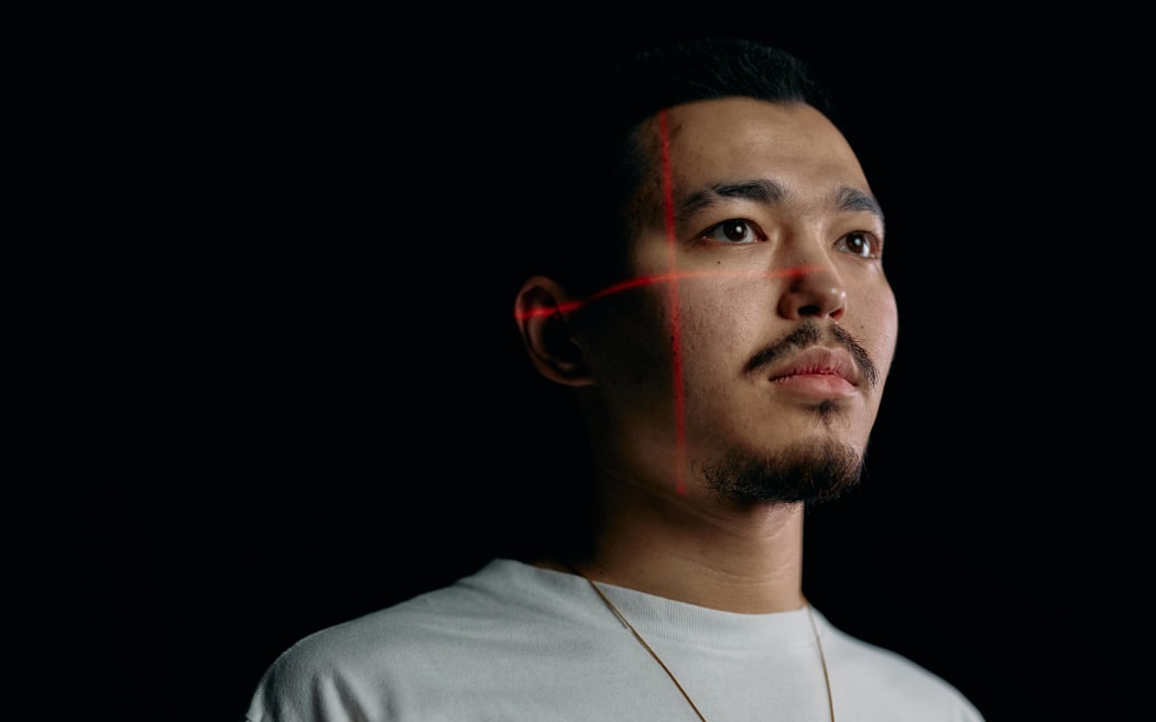 Asian man with laser scanner on his face