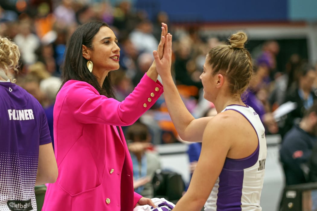 Stars coach Kiri Wills high fives one of her players.