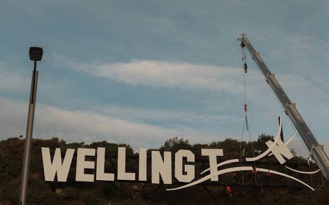 The 'blown away' sign that welcomes those arriving by air into Wellington has had its O taken away. But plans for the letter to be replaced by a football for FIFA Women's World Cup have been kicked to the following day - story on 26/6/23