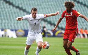 All Whites captain Chris Wood and New Caledonia's Cedric Sansot clash in Kone on 15 November 2016.