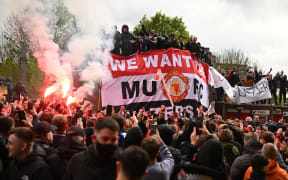 Supporters protest against Manchester United's owners, outside English Premier League club Manchester United's Old Trafford stadium in Manchester, north west England on May 2, 2021, ahead of their English Premier League fixture against Liverpool.