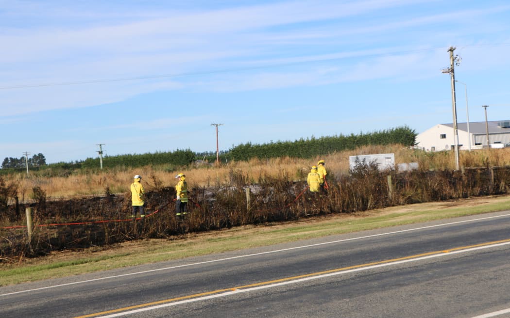 Firefighters fighting a series of fires along the railway line near Kirwee, west of Christchurch.