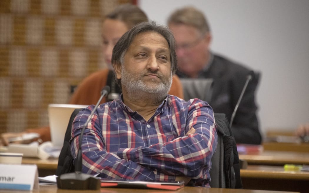Rotorua district councillor Raj Kumar sits with his arms folded.
