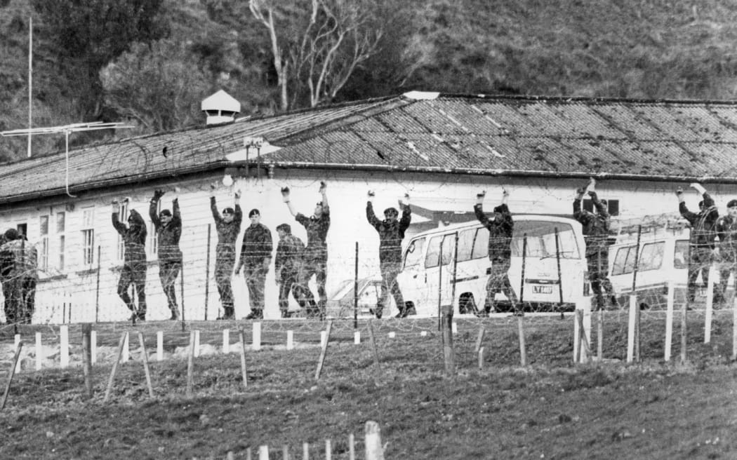 New Zealand Army personnel erecting barbed wire fortifications around the Services Corrective Establishment at Ardmore, Auckland.