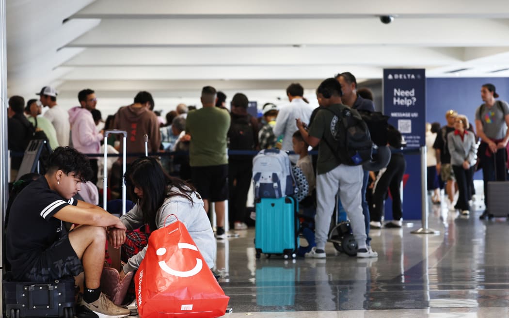 Travelers wait on the check-in floor of the Delta Air Lines terminal at Los Angeles International Airport on 23 July 2024 in the aftermath of the CrowdStrike outage.