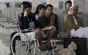 Yemeni men wounded in the Saudi-led coalition strike on a funeral last weekend wait for an Omani plane to evacuate them.