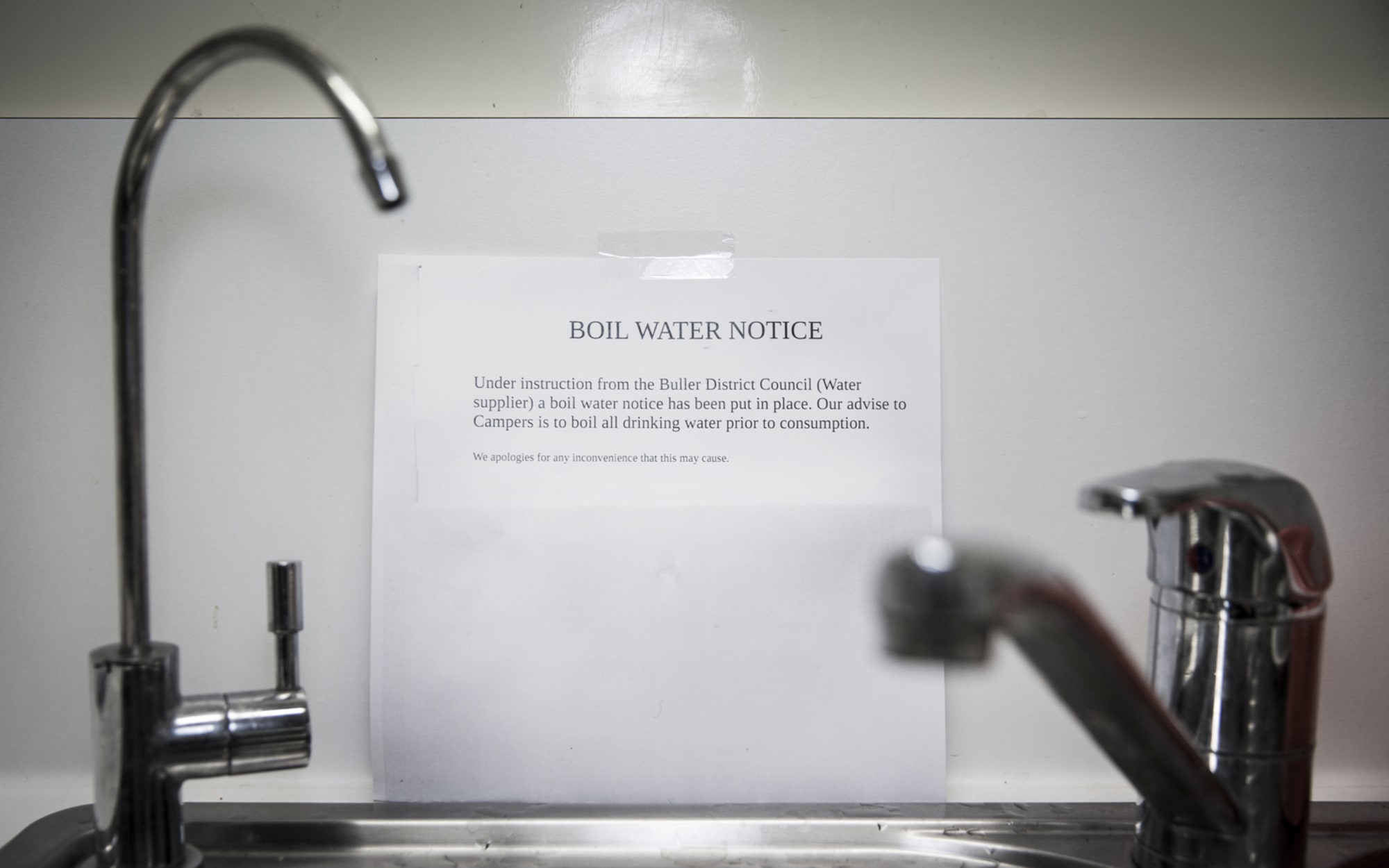 notice on wall behind a sink
