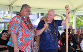 Christopher Luxon and Laʻaulialemalietoa Leuatea Polataivao Fosi Schmidt attend a gift giving ceremony where they received portraits painted by a local Methodist college.
