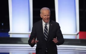 Democratic presidential candidate former Vice President Joe Biden stands on stage after the Democratic Presidential Debate at the Fox Theatre  in Detroit, Michigan.