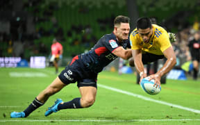 Salesi Rayasi of the Hurricanes (right) scores a try.