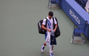NEW YORK, NEW YORK - SEPTEMBER 06: Novak Djokovic of Serbia walks off the court after being defaulted due to inadvertently striking a lineswoman with a ball hit in frustration during his Men's Singles fourth round match against Pablo Carreno Busta of Spain