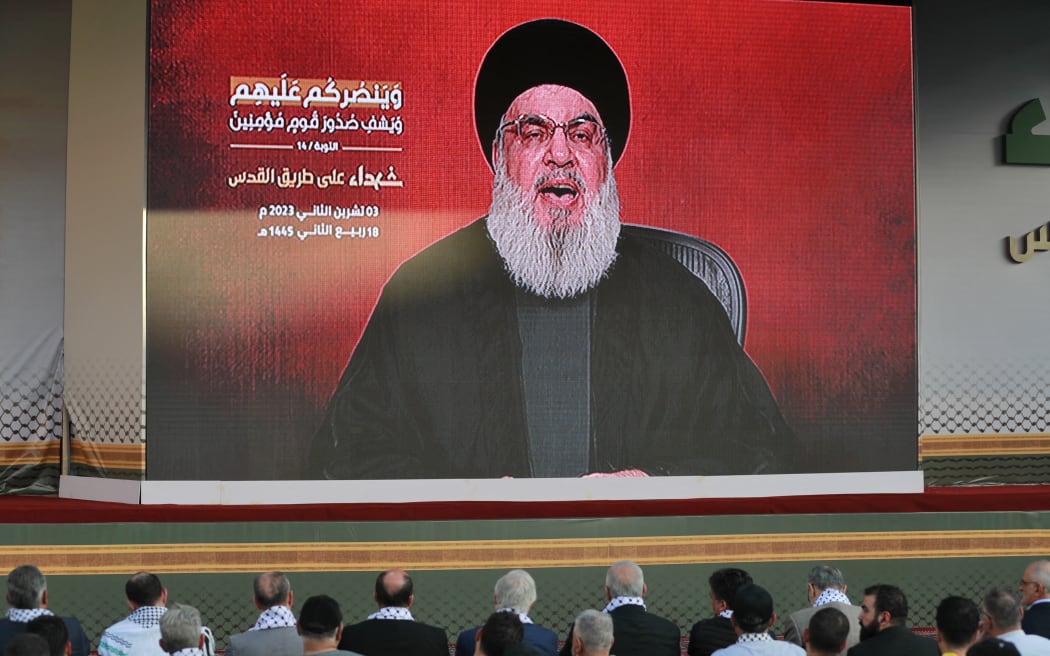 Supporters of the Lebanese Shiite movement Hezbollah watch a televised speech by its leader Hassan Nasrallah in the Lebanese capital Beirut's southern suburbs on November 3, 2023. Nasrallah told the United States on November 3, that his Iran-backed group was ready to face its warships and the way to prevent a regional war was to halt the attacks in Gaza.