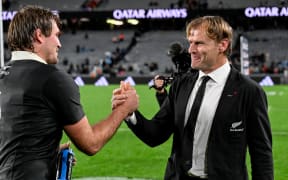 New Zealand coach Scott Robertson shakes hands with Ethan Blackadder.
