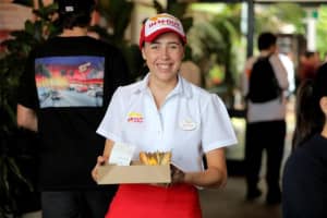 Hundreds of people have lined up for a taste of US burger joint In-N-Out at a pop-up in Auckland.