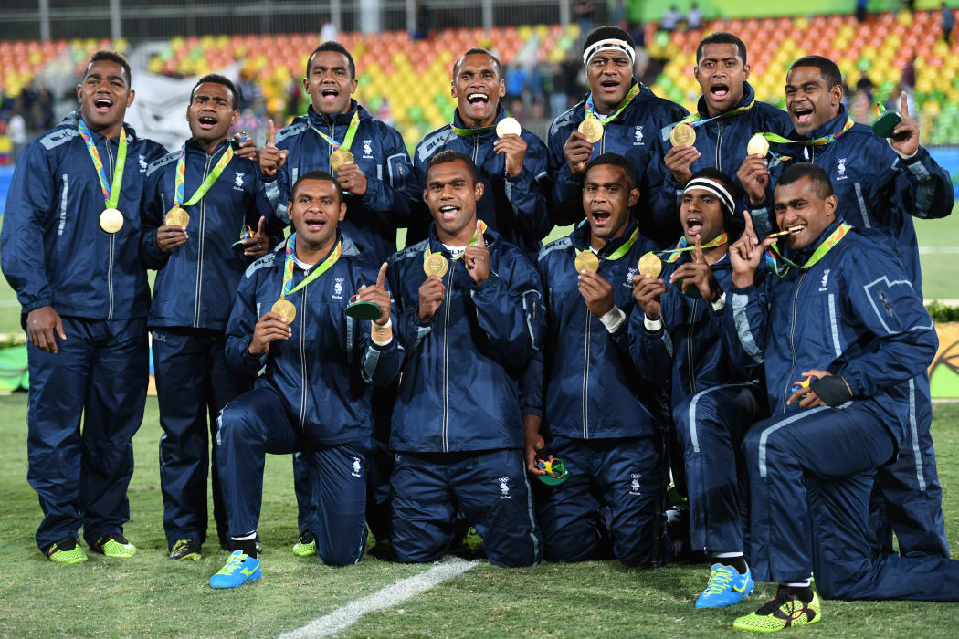 Gold medallists Fiji celebrate during the men’s rugby sevens medal ceremony during the Rio 2016 Olympic Games at Deodoro Stadium in Rio de Janeiro onAugust 11, 2016.