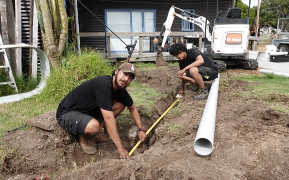 Tauira (trainees) Pete Nathan, front, and Tyreese Martin lay a rainwater pipe.