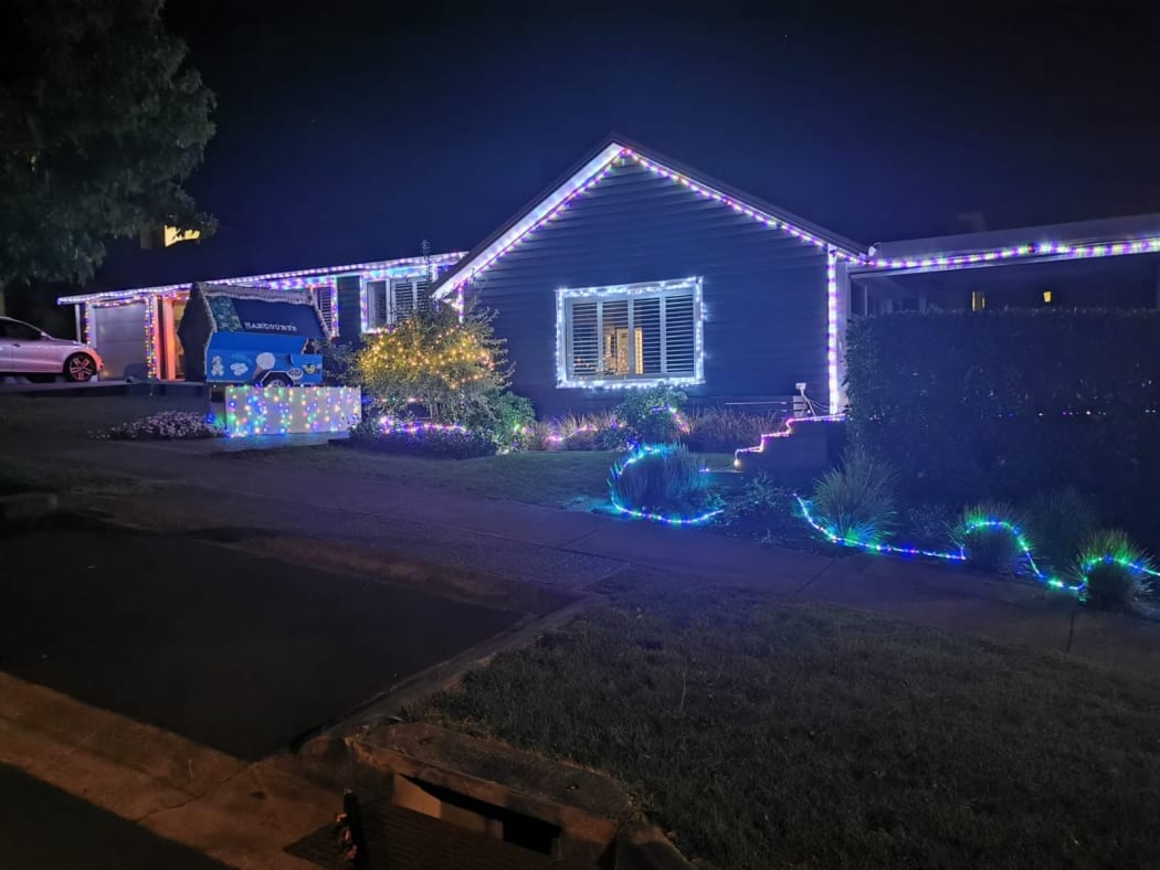 Kevin and Christine Seymour and Cameron Hooper put up their Christmas lights to try and brighten people's moods as they walk past.
