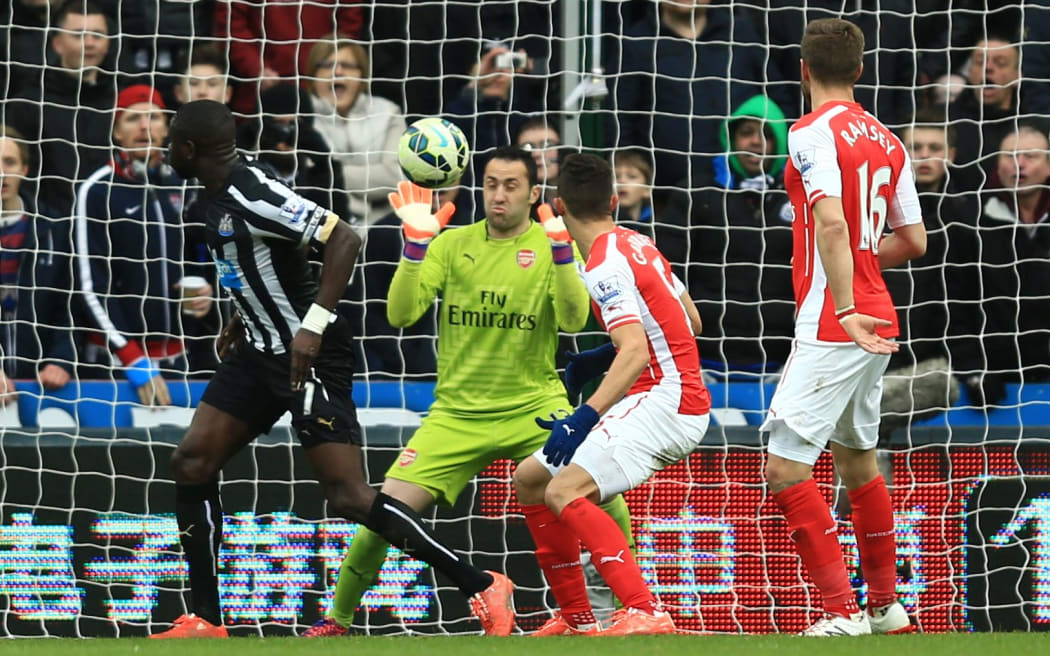 Arsenal goalkeeper David Ospina makes a point-blank save against Newcastle