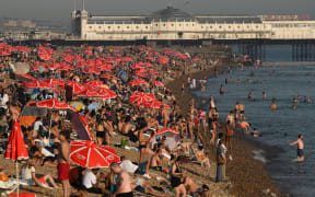 Looking towards the Palace Pier, beachgoers are seen enjoying the sun and the sea on the beach at Brighton, on the south coast of England on September 7, 2023, as the late summer heatwave continues. Last month was the world's hottest September on record by an "extraordinary" margin, adding to record-breaking global temperatures during the Northern Hemisphere summer, the EU climate monitor said on Thursday.