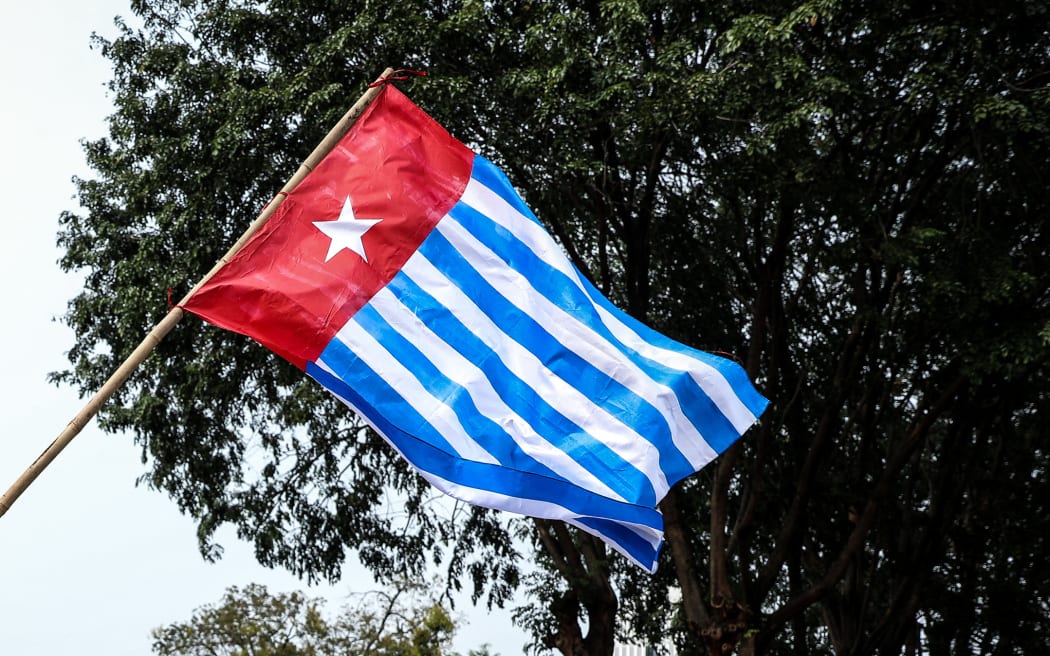 A Papuan student waves the West Papua flag, the Morning Star during a rally in Jakarta, Indonesia, on 28 August, 2019.