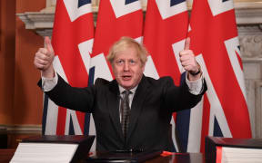 Boris Johnson gives a double thumbs up after signing the Trade and Cooperation Agreement between the UK and the EU, the Brexit trade deal, at 10 Downing Street in central London on 30 December  2020.