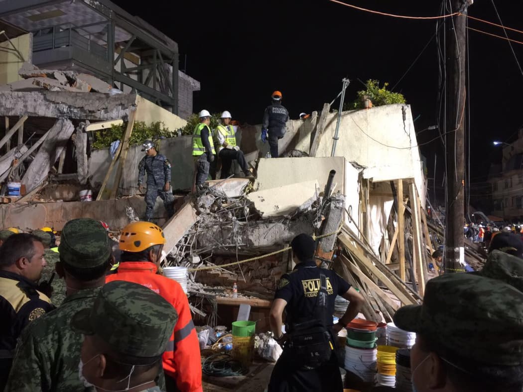 Rescue teams search Rébsamen school in Mexico City overnight for people still missing.