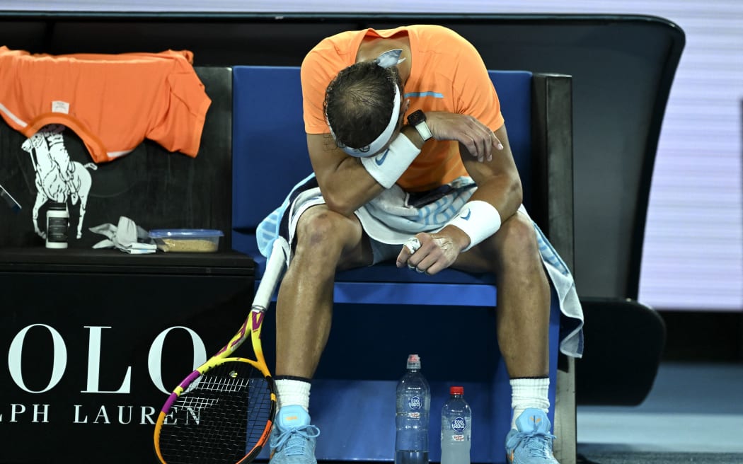 Spain's Rafael Nadal takes rest during his match against Mackenzie McDonald of the US at the 2023 Australian Open.