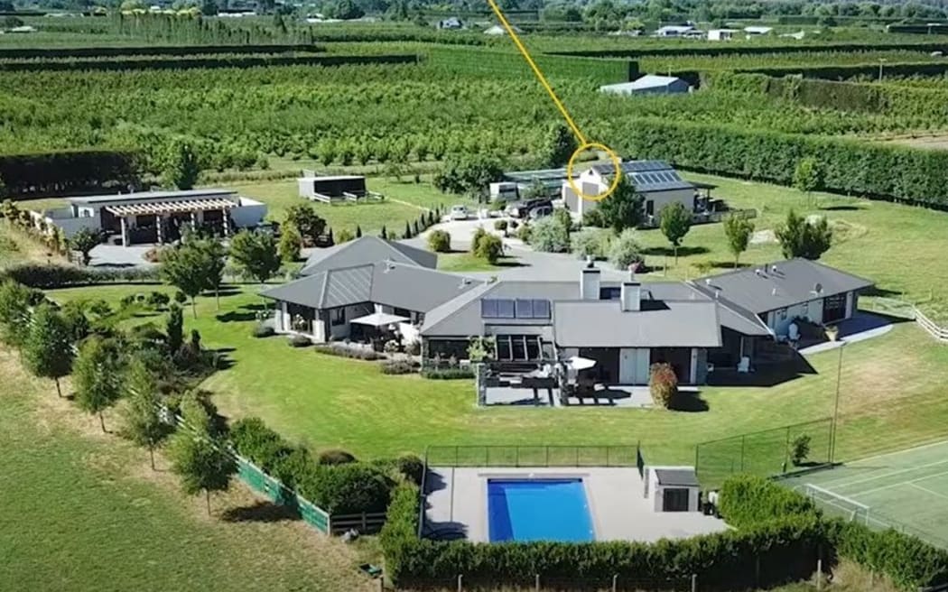 Wayne and Lynn Simpson's home in Pakowhai, pictured before the flood brought by Cyclone Gabrielle, with a circle showing the tip of roof that remained above the water where the couple and guests waited for rescue.