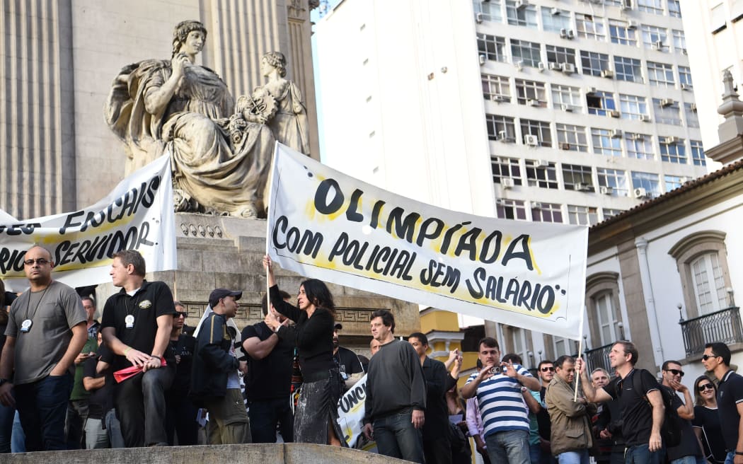 Civil police officers demonstrate against the government for arrears in their salary payments after state authorities declared a "state of public calamity" over a major budget crisis, granting additional funds to the Olympic Games.