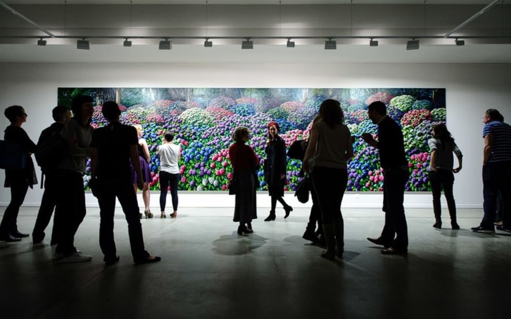 Visitors to the opening of 'Solo' look at 'Hydrangeas' by Karl Maughan.