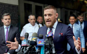 Conor McGregor talks to the press after he pleaded guilty to a single violation of disorderly conduct, in Brooklyn Criminal Court.