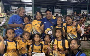 The Nauru under-10 girls team with their runner-up trophy in Nadi.