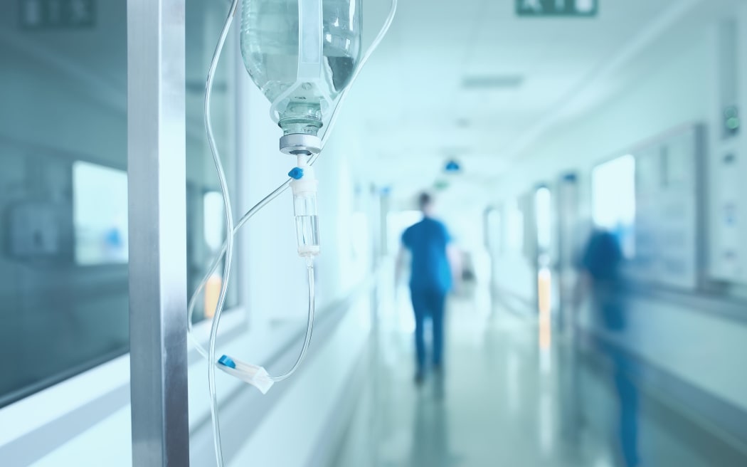 Silhouette of a doctor walking in a hurry in the hospital corridor.