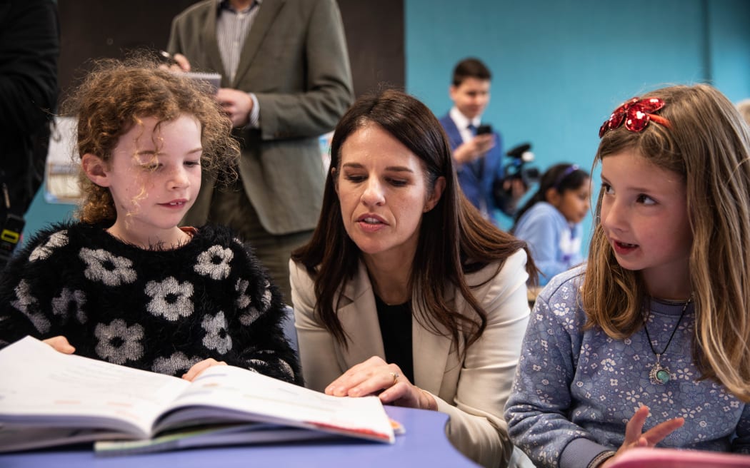 Minister of Education Erica Stanford reading to a pupil at Ridgway School in Wellington, in August 2024.
